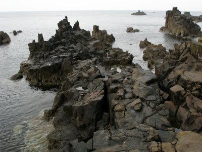 Eroded basalt rocks at the water's edge