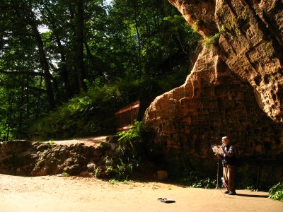 Recorder player beside the outer cave wall