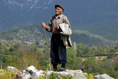 a goat's shepherd standing on a hill of Tlos