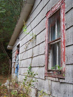 Abandonded cabin and cigar smoker