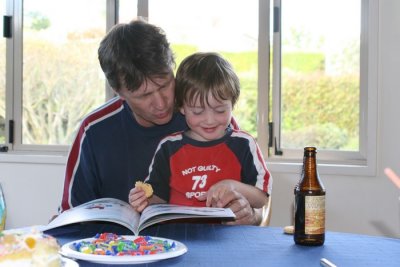 Daddy reading Caleb's birthday book to him