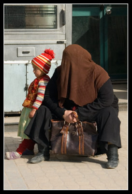 Woman wearing burka and children