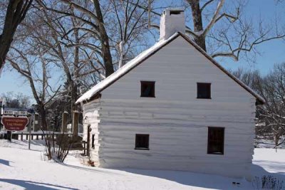 Old Log House in Blizzard