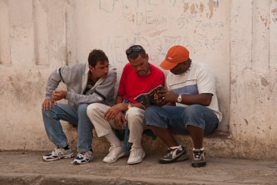 3 men on a street corner bench