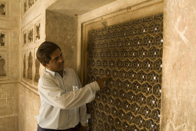 our guide at the Agra Fort shows us a carved marble screen.jpg