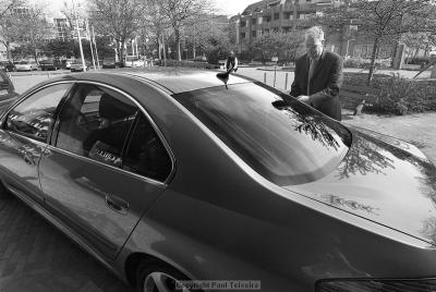 The mayors driver preparing the car for his boss
