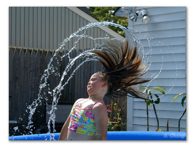Sarah playing in the water with her hair