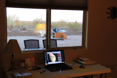 The laptop on the desk is remotely controlling the computer in the yard.
