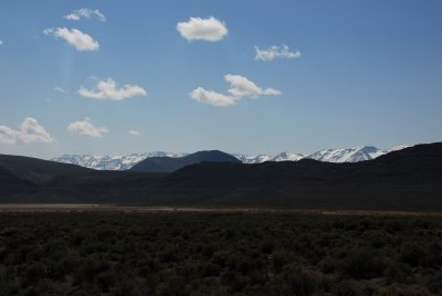 A dry lake, hills and Steens Mountain