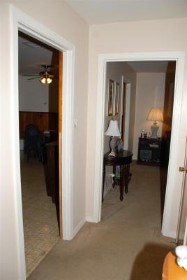 View of hallway opening to kitchen and front room
