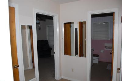 End of hallway opening up to all three bedrooms, bathroom and closets