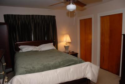 Front bedroom 2, largest, windows covered with dark blinds