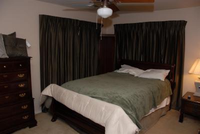 Front bedroom 2, largest, windows covered with dark blinds 2