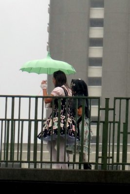 Umbrella girls on overpass