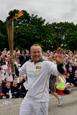 Kevin Stockley, chairman of amateur football league Birkdale United carries the Olympic Torch From sixth form college KGV Southport UK. Finishing the day in Liverpool.