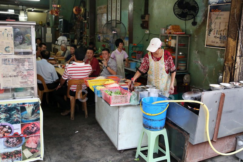 Cook in a restaurant in Chinatown, Kuala Terengganu