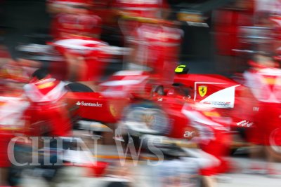 Ferrari's crew practices pit-stop