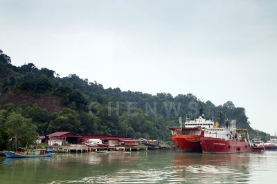 Boats working in the offshore petroleum industry moor at the mouth of the river, Terengganu