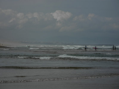 Surfers and distant Biarritz