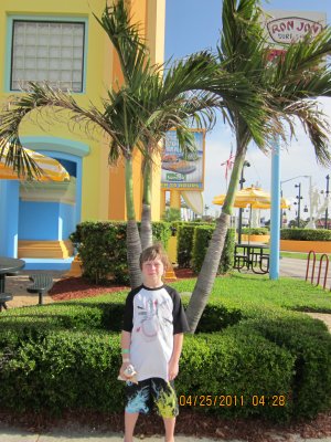 Ian next to a palm tree at Ron Jons surf shop