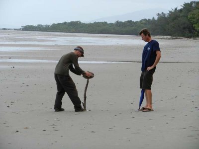 Mark tries to open a coconut on Myall Beach