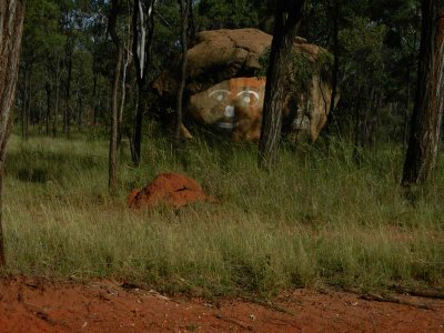 Termite mound and whimsical rock graffito