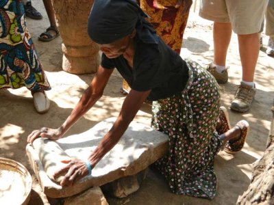 Villager demonstrates how to grind maize for nshima