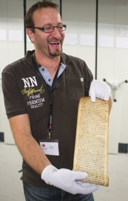 A very old manuscript, rolled (around 2 meters long).