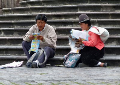 Checking their lottery tickets.