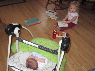 Kristina reads to her sister