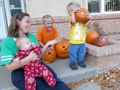 Kristina confuses a pumpkin for a basketball