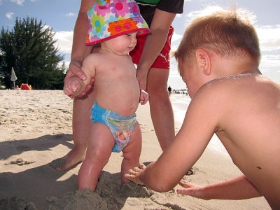 Simon buries Annie's feet in sand