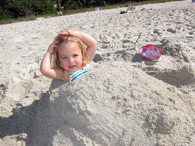Kristina lounging in a sand-mound
