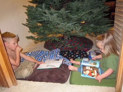 Kids stake out territory behind the tree