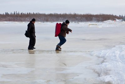 People walking on river at high tide