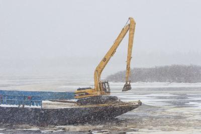 Barge carries excavator to help with ice