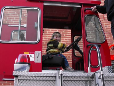 Connor loves sitting in the rear-steer compartment of this county ladder truck. One of the firefighters was from Hyde Park, MA.