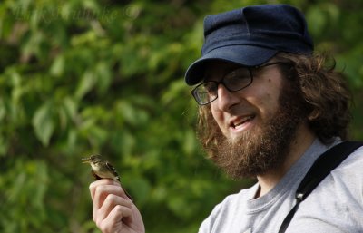 Ken teaching about banding birds, with a banded flycatcher in-hand