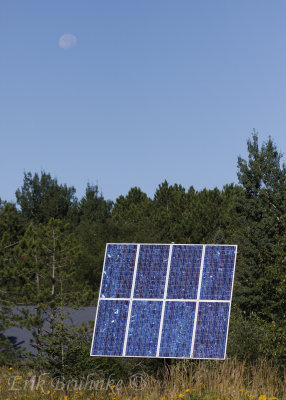 Solar panel in front of Hartley Nature Center and the moon