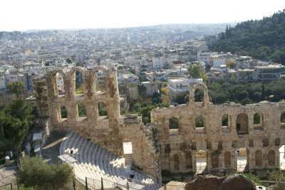 Panoramic view of Athens against the majesty of the Theater of Herod Atticus.