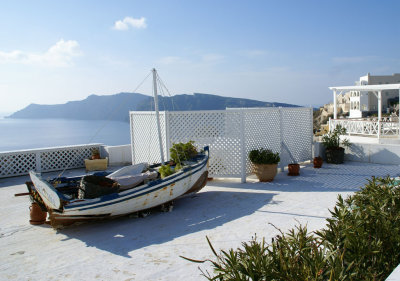 Fishing boat perched on the roof of adobe in Oia.