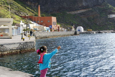 Landlubber chucking stones with glee, from the Santorini harbor.