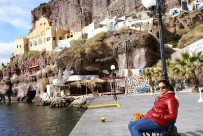 Landlubber relaxing at the Santorini Harbor, with medieval fortress looming large in the background.