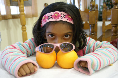 Uma, her glares and the freshly plucked oranges make for a delicious combo!:-)