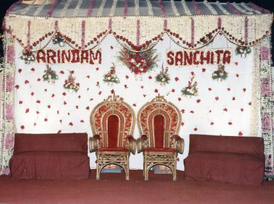 Reception Stage and Throne in Bombay, bedecked with flowers- the names have been embellished in red roses.