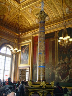 Ornate pillar and works of art adorn the Versailles Palace.