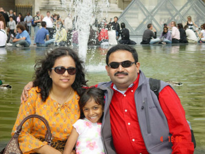 In front of the famous Glass Pyramid by American Architect I.M. Pei, flanking the Louvre.