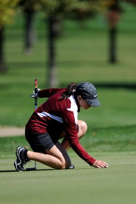 Amber placing her ball to putt on #7