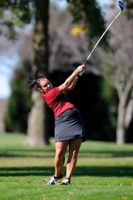 Kayla finishes her swing on the 14th tee