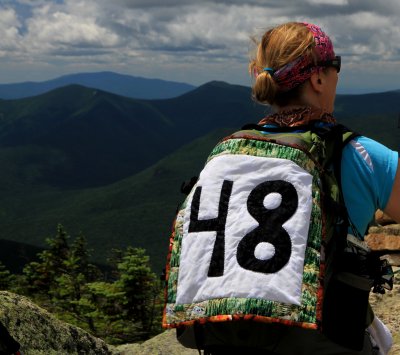 A hiker taking a break on Bond before climbing Bondcliff--her # 48!